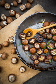Crimini mushrooms with garlic and basil in pan, braised