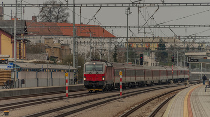 Obraz premium Fast passenger train with red modern electric engine in Ilava station