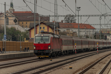 Fast passenger train with red modern electric engine in Ilava station