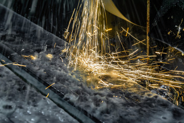 Sparks flying from abrasive stone when grinding on a water-cooled machine.