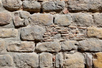 Very old vintage wall from large stones of various shapes and bricks