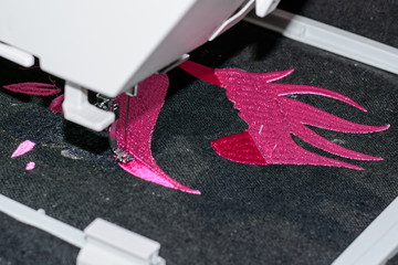 Machine embroidering beautiful girl.  Close up