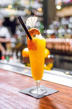 Beverage filled clear footed cup with straw