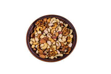 Various nuts (almond, cashew, hazelnut, pistachio, walnut) in ceramic plate isolated on a white background. Vegetarian meal. Healthy eating concept