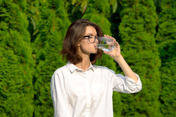 Girl drinks water.
