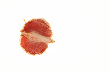 Half of the grapefruit is lying on a white background