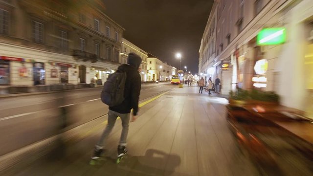 Man doing jump on inline skates in motion blur