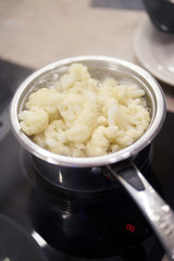 Boiling in pan cauliflower. Vegetarian dinner cooking