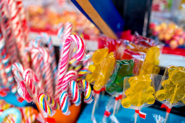 Sweet candy in different shapes and colorful designs at Christmas market. 