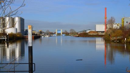 Naklejka premium Industrial park on the inner harbor with bio energy plant and tank storage in Cuijk