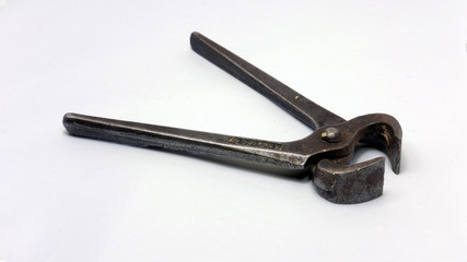 A vintage carpenter's pincers on a white background