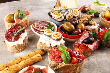 Appetizers table with italian antipasti snacks and wine in glasses. Brushetta or authentic traditional spanish tapas set, cheese variety