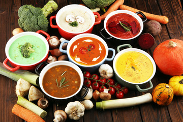 Variety of colorful vegetables cream soups and ingredients for soup. Concept of healthy eating or vegetarian food with mushrooms