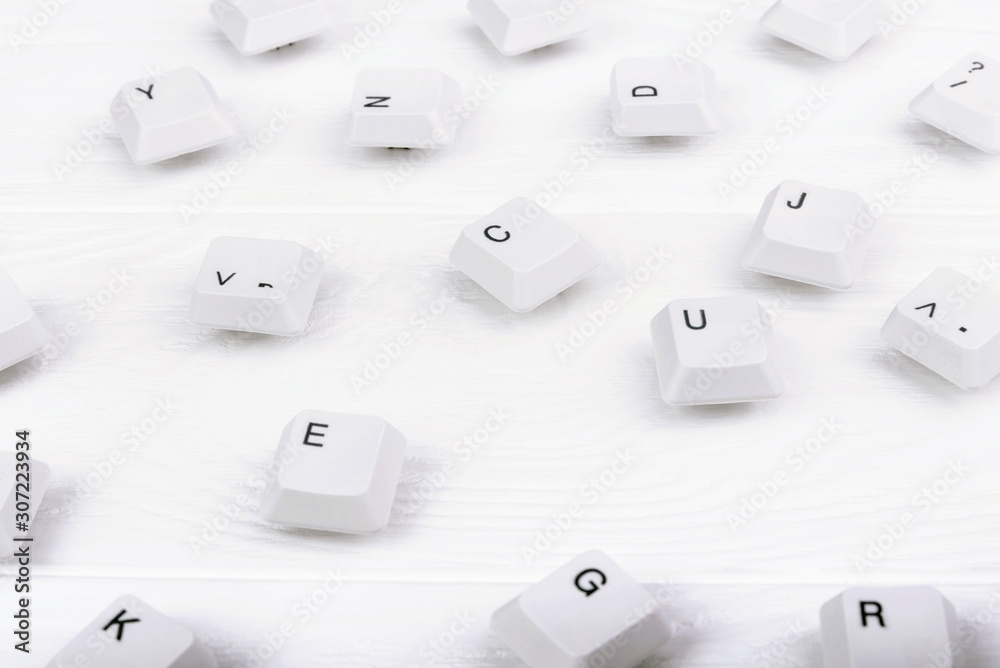 Fototapete keyboard keys isolated. white keyboard keys on white wooden background. top view. close up