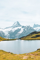 Beautiful Bachalpsee in the Swiss Alps photographed with famous mountain peaks Eiger, Jungfrau, and Monch. Alpine lake and landscape. Snow-capped mountains, mountain range. Switzerland nature