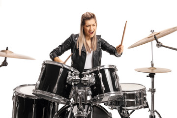 Obraz na płótnie Canvas Female drummer playing on a set of drums