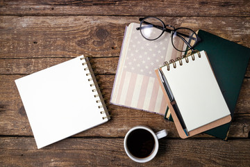 Office desk table with coffee cup, american history book, pen, notebook and eyeglasses. Educations, resolutions, goal, plan, strategy, politics, international relations, economics concept