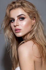 Fototapeta premium Portrait of young beautiful blond model with a day professional make up and perfect bright skin.