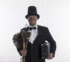 portrait of a chimney sweep in soot, a brush for cleaning chimneys