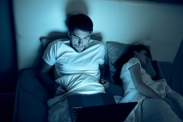 man sitting on sofa with laptop