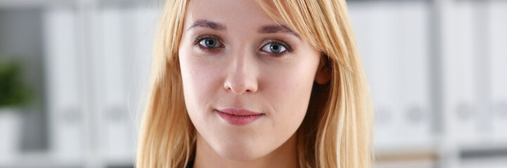 Fototapeta premium Beautiful smiling girl at workplace look in camera