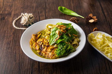 Pasta with meat and vegetables in plate on white wooden background Copyspace Top side view