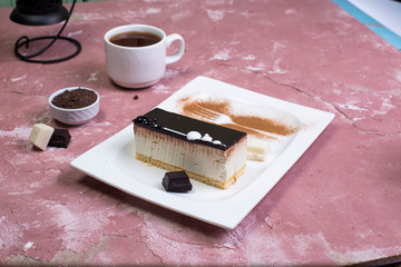 cup of tea and chocolate cheese cake on the table