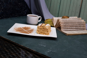 cup of tea and sweet cake with dark blue background