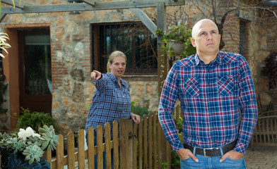 Annoyed man with scolding female neighbor