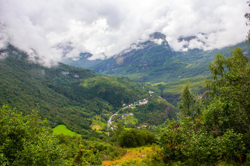 Fototapeta premium View of the mountain valley. Around everything is covered with green trees