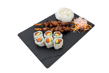 High angle shot of tasty delicious sushi rolls and barbecue skewers  with a side of garnish