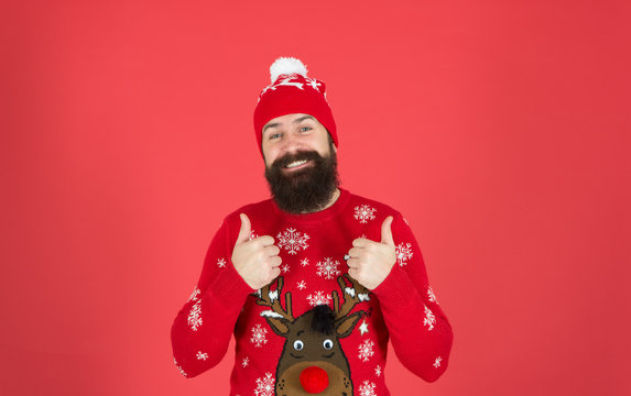 Feeling awesome. Buy festive clothing. Sweater with deer. Hipster cheerful bearded man wear winter sweater and hat. Happy new year. Join holiday party craze and host ugly christmas sweater party