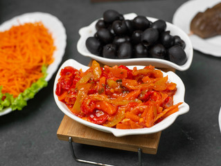 black olives and colorful pepper salad on the table