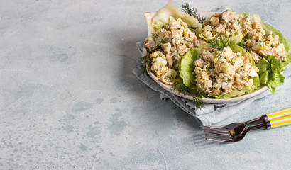 Calamari or squid salad with rice, egg, onion and dill served with green lettuce leaves. Delicious fresh salad. Keto diet.