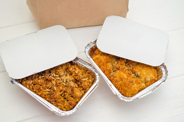 Indian food, fruit pies, subhadra and mithai, in foil plates on a white background, sprinkled with seeds, near paper bag, mockup