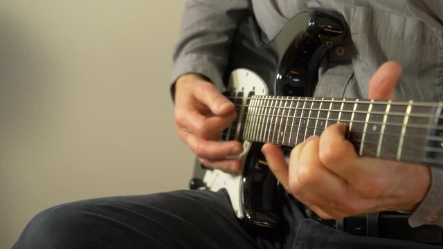 Playing a song up and down the neck of an electric guitar 4K