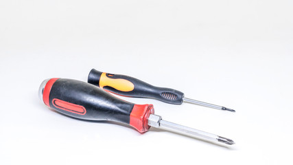 Two screwdrivers lie on a white background. Isolated view.
