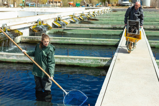 Male and female fish farm workers