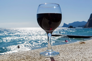 A glass of wine on the background of the sea.