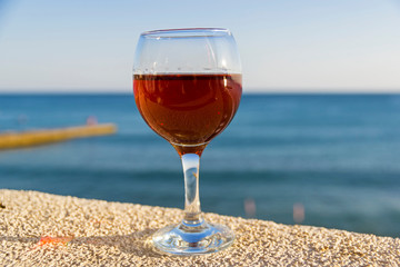 A glass of wine on the background of the sea.
