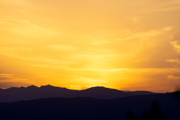 Beautiful silhouette of mountains during sunset with a golden sky