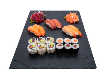 Artfully Delicious: Beautiful Assortment of Fresh Sushis Presented on Black Slate for Restaurant Menu