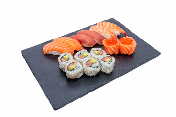 Artfully Delicious: Beautiful Assortment of Fresh Sushis Presented on Black Slate for Restaurant Menu