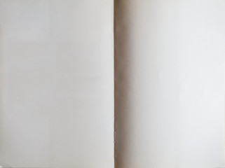 White book unfolded showing blank pages.