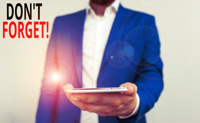 Word writing text Don T Forget. Business photo showcasing used to remind someone about important fact or detail Business concept with man holding mobile phone with touch screen