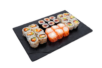High angle shot of different sushi rolls on a black tray isolated on a white background