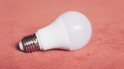 Light bulbs on a soft fluffy peach-colored background