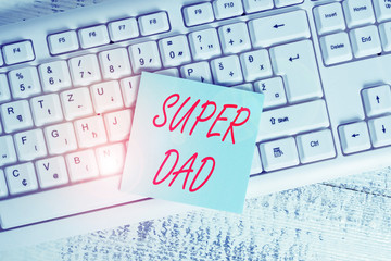 Conceptual hand writing showing Super Dad. Concept meaning Children idol and super hero an inspiration to look upon to Keyboard office supplies rectangle shape paper reminder wood