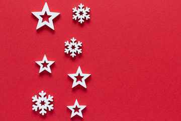 Christmas composition. Snowflakes and stars on red background top view background with copy space for your text. Flat lay.