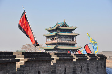 Typical chinese temple with flags in the city of PingYao taken from the city walls